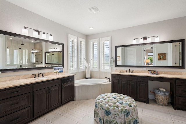 full bathroom featuring a bath, two vanities, tile patterned floors, a shower stall, and recessed lighting