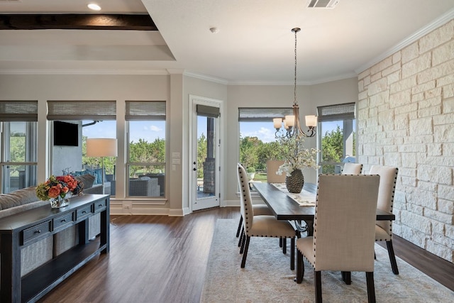 dining room with wood finished floors, a chandelier, and crown molding