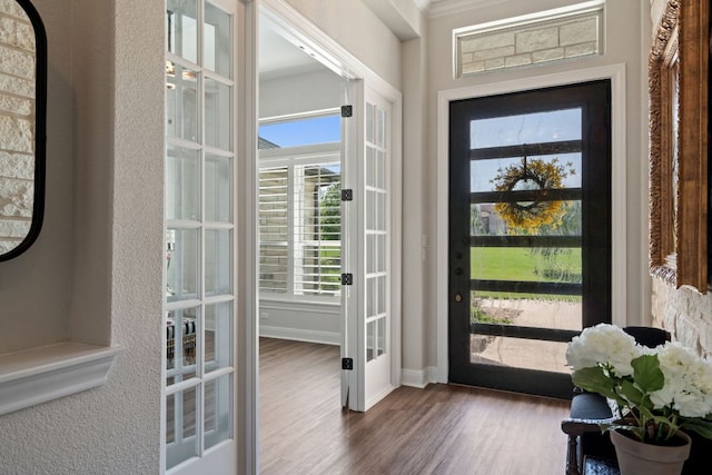 entryway with wood finished floors, healthy amount of natural light, french doors, and baseboards