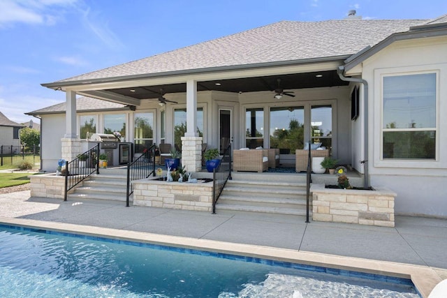 rear view of property with a ceiling fan, a patio area, and outdoor lounge area