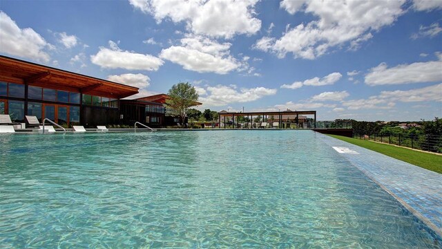 view of swimming pool with fence