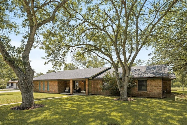 1619 Twin Island Dr, Lockhart, TX 78644 - single story home featuring a front lawn, brick siding, and a shingled roof