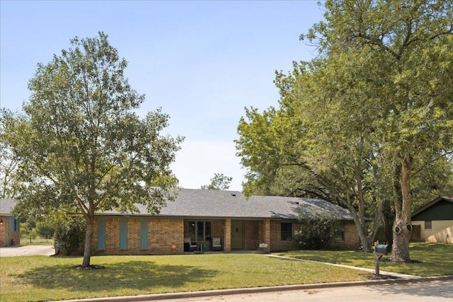 1619 Twin Island Dr, Lockhart, TX 78644 - single story home with a front yard and brick siding