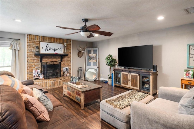 1619 Twin Island Dr, Lockhart, TX 78644 - living room featuring a ceiling fan, wood finished floors, a fireplace, a textured ceiling, and recessed lighting