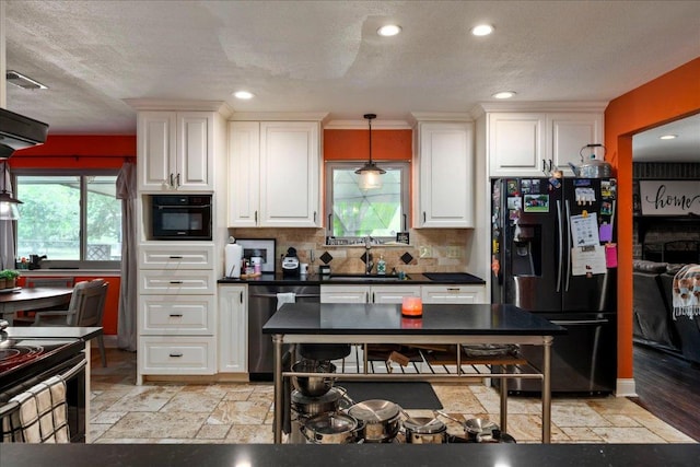 1619 Twin Island Dr, Lockhart, TX 78644 - kitchen with black fridge with ice dispenser, dishwasher, dark countertops, white cabinetry, and a textured ceiling