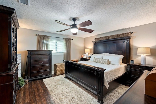 1619 Twin Island Dr, Lockhart, TX 78644 - bedroom with dark wood finished floors, a textured ceiling, and ceiling fan