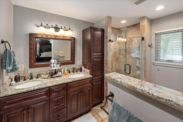 1619 Twin Island Dr, Lockhart, TX 78644 - bathroom featuring double vanity, a shower stall, and recessed lighting