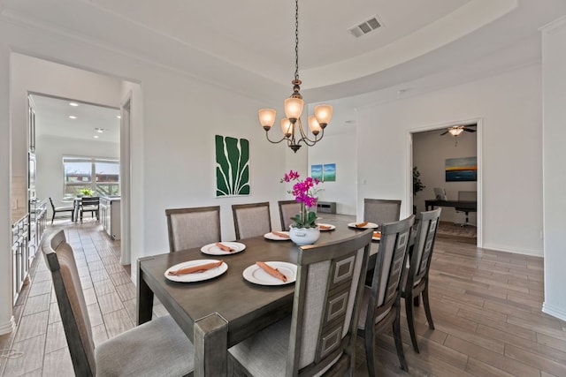 dining area with wood finished floors, a chandelier, baseboards, and recessed lighting