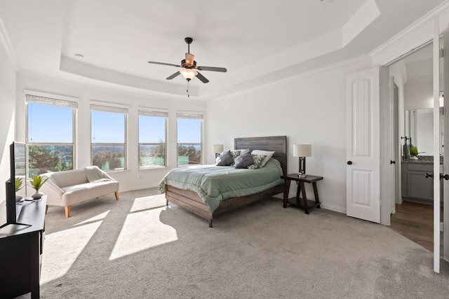 bedroom featuring a tray ceiling, baseboards, carpet flooring, and ceiling fan