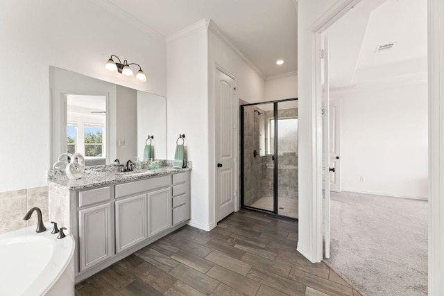 full bath with ornamental molding, a stall shower, a garden tub, vanity, and baseboards