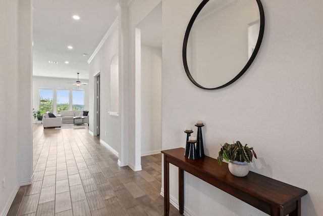 hall with recessed lighting, baseboards, wood finished floors, and decorative columns