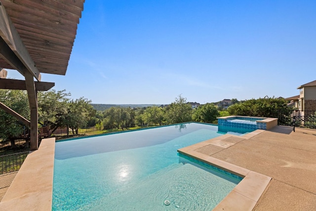 view of swimming pool with a pool with connected hot tub and a patio