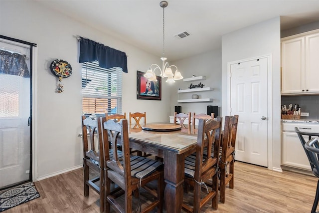 651 Bayberry Cir, Buda, TX 78610 - dining area featuring a chandelier and light wood-style flooring