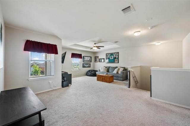 651 Bayberry Cir, Buda, TX 78610 - living room with carpet floors, a ceiling fan, baseboards, and a tray ceiling
