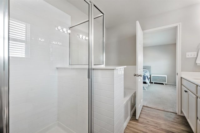 651 Bayberry Cir, Buda, TX 78610 - full bathroom featuring ensuite bath, vanity, a stall shower, and wood finished floors