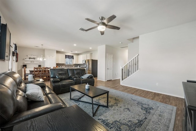 651 Bayberry Cir, Buda, TX 78610 - living room with a ceiling fan, stairs, dark wood-style floors, baseboards, and recessed lighting