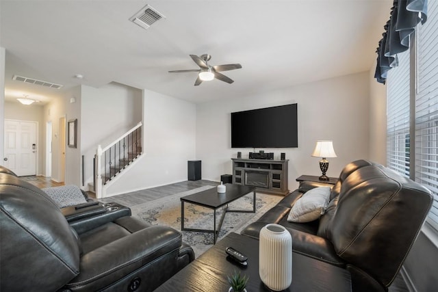 651 Bayberry Cir, Buda, TX 78610 - living room with stairway, ceiling fan, healthy amount of natural light, and wood finished floors