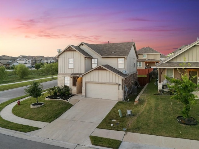 651 Bayberry Cir, Buda, TX 78610 - view of front of house featuring board and batten siding, driveway, a residential view, stone siding, and an attached garage