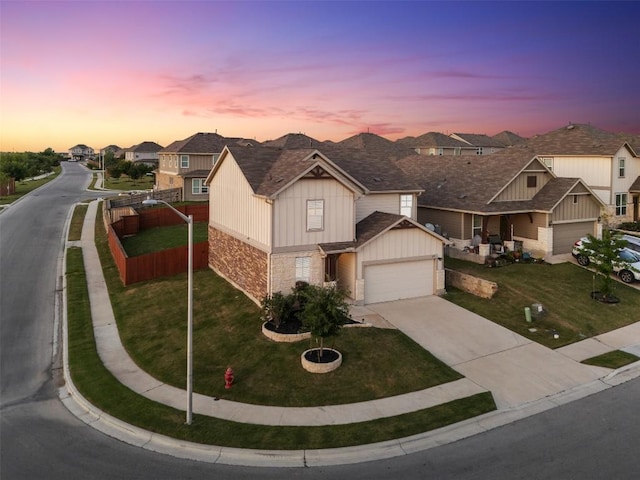 651 Bayberry Cir, Buda, TX 78610 - view of front facade with board and batten siding, driveway, a residential view, stone siding, and a garage