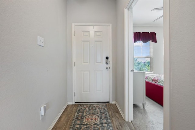 651 Bayberry Cir, Buda, TX 78610 - doorway with wood finished floors and baseboards