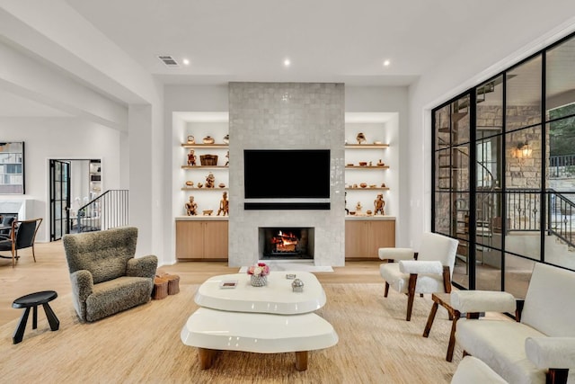3204 Aztec Fall Cv, Austin, TX 78746 - living area with light wood finished floors, a tile fireplace, built in features, and recessed lighting