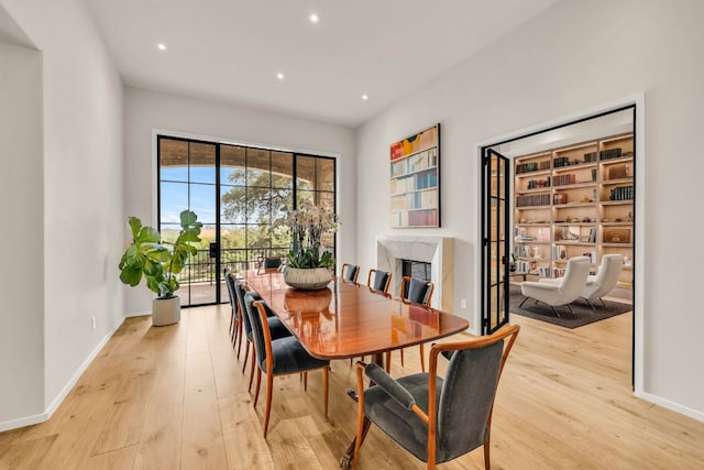 3204 Aztec Fall Cv, Austin, TX 78746 - dining space with light wood-type flooring, baseboards, recessed lighting, and a premium fireplace
