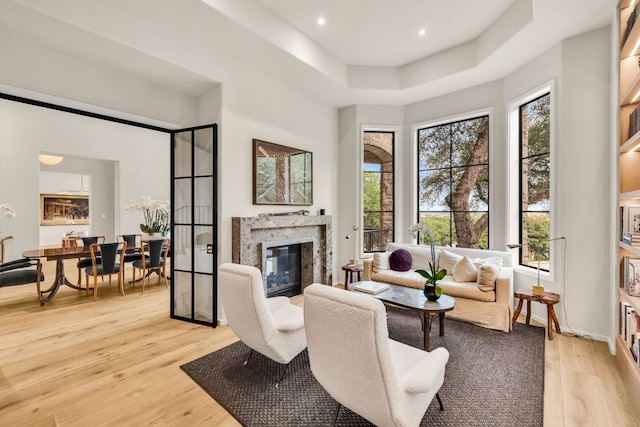 3204 Aztec Fall Cv, Austin, TX 78746 - living room with light wood-style flooring, a high end fireplace, and recessed lighting