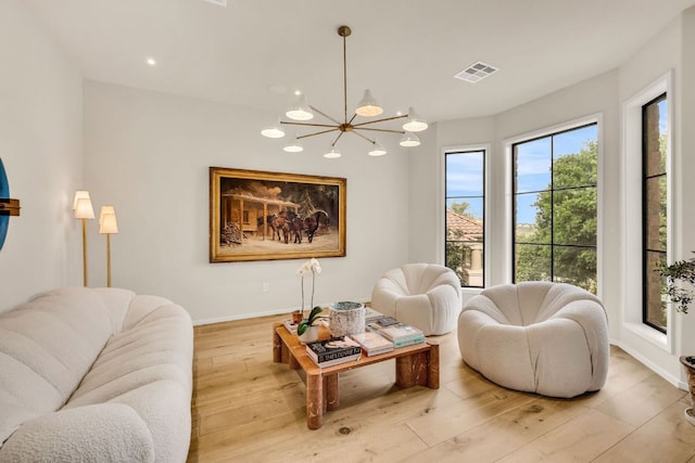 3204 Aztec Fall Cv, Austin, TX 78746 - living room with a chandelier, light wood-style floors, baseboards, and recessed lighting