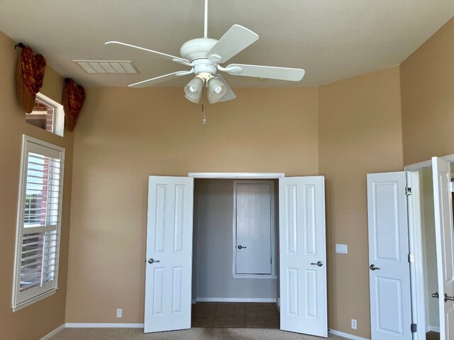 209 Country Creek Dr, Austin, TX 78737 - unfurnished bedroom with a towering ceiling, baseboards, and ceiling fan