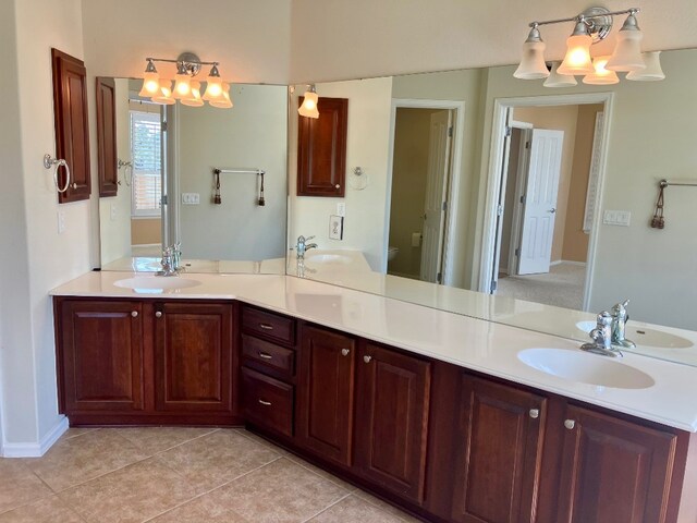 209 Country Creek Dr, Austin, TX 78737 - full bath featuring a chandelier, double vanity, tile patterned flooring, and toilet