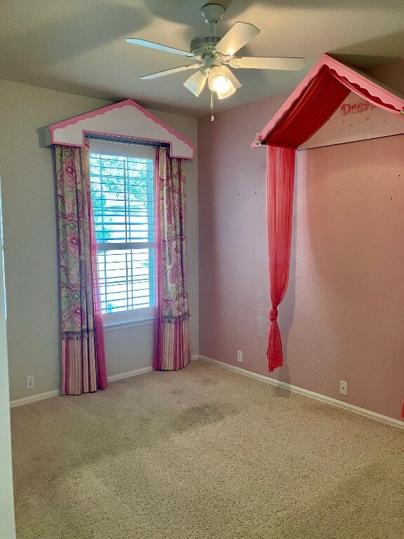 209 Country Creek Dr, Austin, TX 78737 - spare room with a ceiling fan, carpet floors, and baseboards
