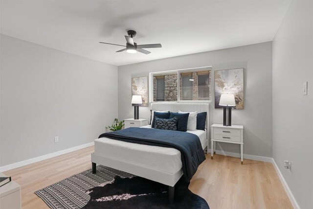 10107 E Rutland Vlg, Austin, TX 78758 - bedroom with light wood finished floors and a ceiling fan