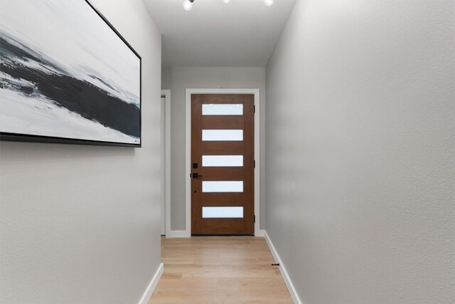 10107 E Rutland Vlg, Austin, TX 78758 - doorway to outside with light wood-style flooring and baseboards