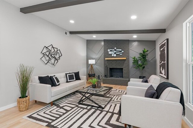 10107 E Rutland Vlg, Austin, TX 78758 - living room with beam ceiling, wood finished floors, recessed lighting, and a brick fireplace