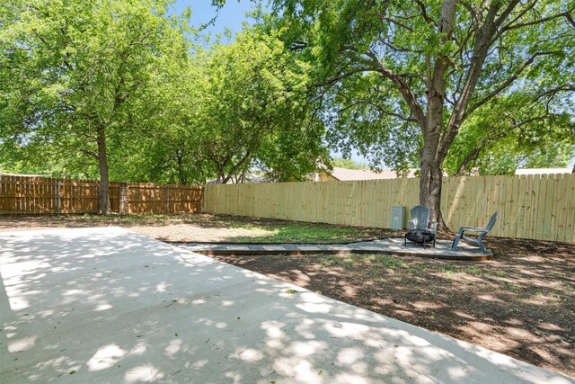 10107 E Rutland Vlg, Austin, TX 78758 - fenced backyard featuring a patio area and an outdoor fire pit