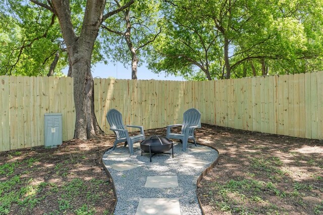 10107 E Rutland Vlg, Austin, TX 78758 - fenced backyard with an outdoor fire pit