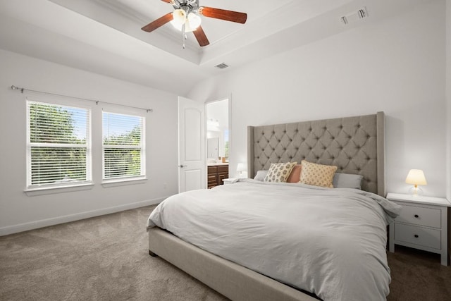 carpeted bedroom with baseboards, a tray ceiling, and ceiling fan