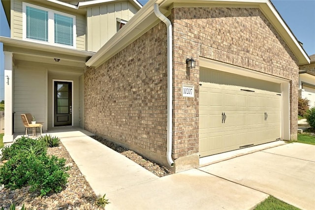 10207 Buster Dr, Austin, TX 78748 - view of side of property featuring brick siding, a garage, and concrete driveway