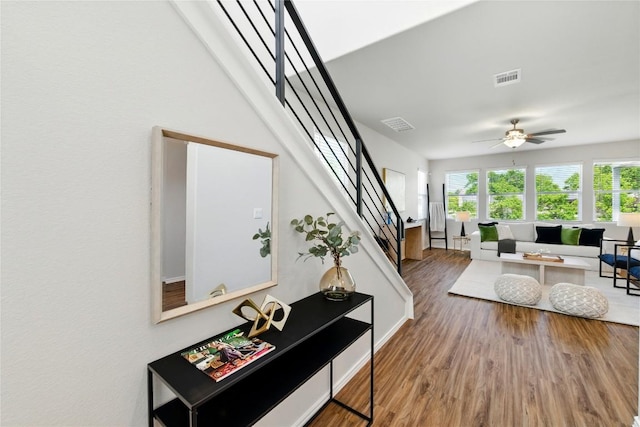 10207 Buster Dr, Austin, TX 78748 - living room featuring wood finished floors, stairs, ceiling fan, and baseboards