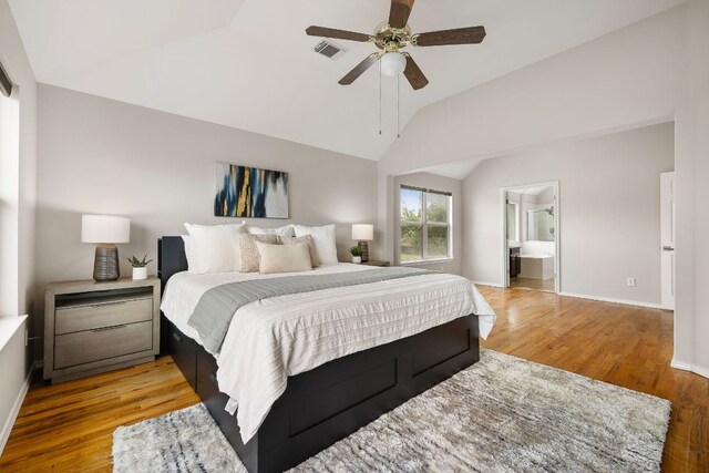 701 Stansted Manor Dr, Pflugerville, TX 78660 - bedroom featuring light wood-type flooring, vaulted ceiling, ensuite bath, and a ceiling fan