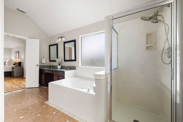 701 Stansted Manor Dr, Pflugerville, TX 78660 - ensuite bathroom featuring tile patterned floors, a shower stall, lofted ceiling, a bath, and vanity