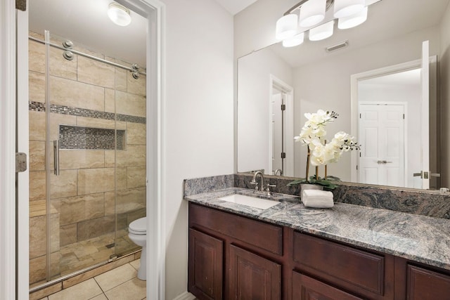 701 Stansted Manor Dr, Pflugerville, TX 78660 - full bathroom featuring a shower stall, toilet, tile patterned flooring, and vanity