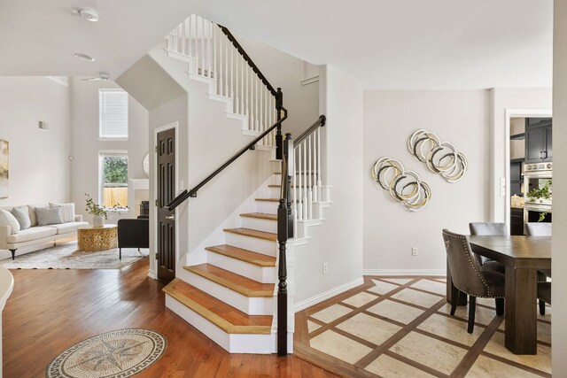 701 Stansted Manor Dr, Pflugerville, TX 78660 - stairway featuring a high ceiling and wood finished floors
