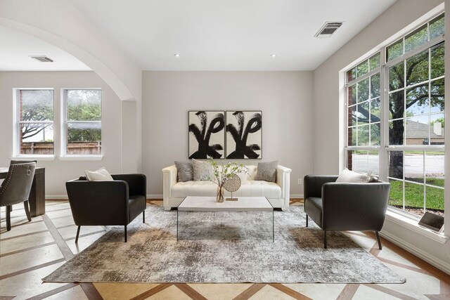 701 Stansted Manor Dr, Pflugerville, TX 78660 - living room featuring healthy amount of natural light and arched walkways