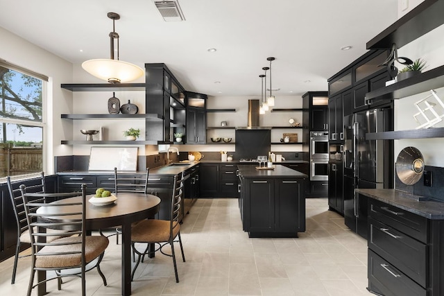 701 Stansted Manor Dr, Pflugerville, TX 78660 - kitchen with open shelves, dark cabinetry, dark countertops, freestanding refrigerator, and a sink