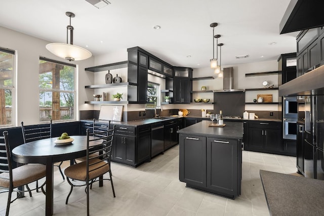 701 Stansted Manor Dr, Pflugerville, TX 78660 - kitchen with open shelves, dark countertops, stainless steel appliances, dark cabinetry, and wall chimney range hood