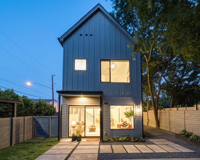 1908 Goodrich Ave Unit B, Austin, TX 78704 - rear view of property with board and batten siding, a fenced backyard, and a gate