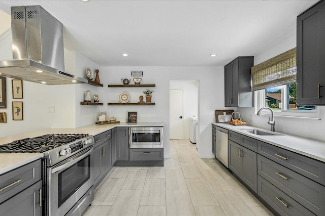 kitchen with stainless steel appliances, a sink, range hood, light countertops, and open shelves