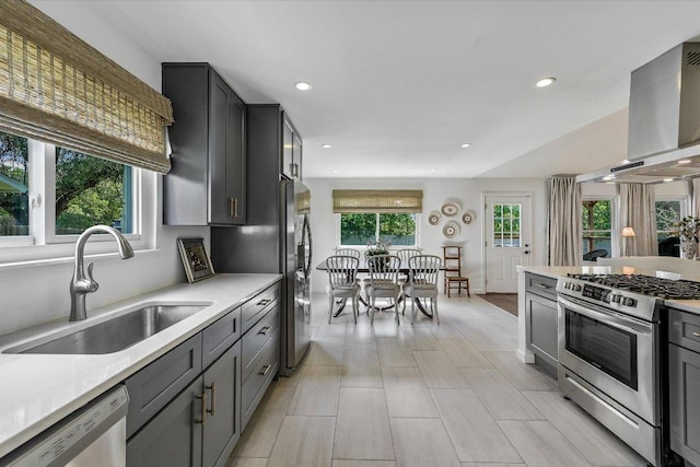 6201 Sun Vista Dr, Austin, TX 78749 - kitchen with appliances with stainless steel finishes, wall chimney exhaust hood, a sink, light countertops, and recessed lighting