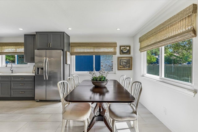 dining space featuring recessed lighting, light tile patterned flooring, and baseboards